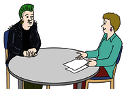 Leichte Sprache: Ein Jugendlicher mit grünen Haaren sitzt an einem Beratungstisch mit einer Frau