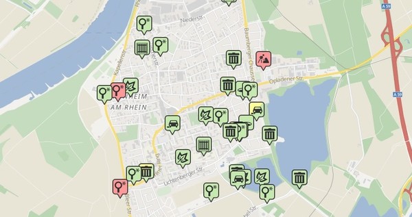 Eine Karte zeigt alle Meldungen, die gerade bearbeitet werden. Die roten Meldungen werden noch geprüft, gelbe bearbeitet, grüne sind gelöst und gelb/grüne ungelöst abgeschlossen. Screenshot: Mängelmelder Monheim am Rhein
